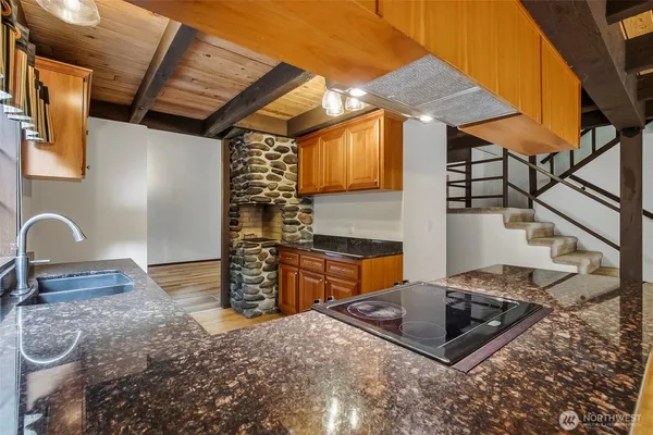 a kitchen with stainless steel appliances granite countertop a sink stove and cabinets