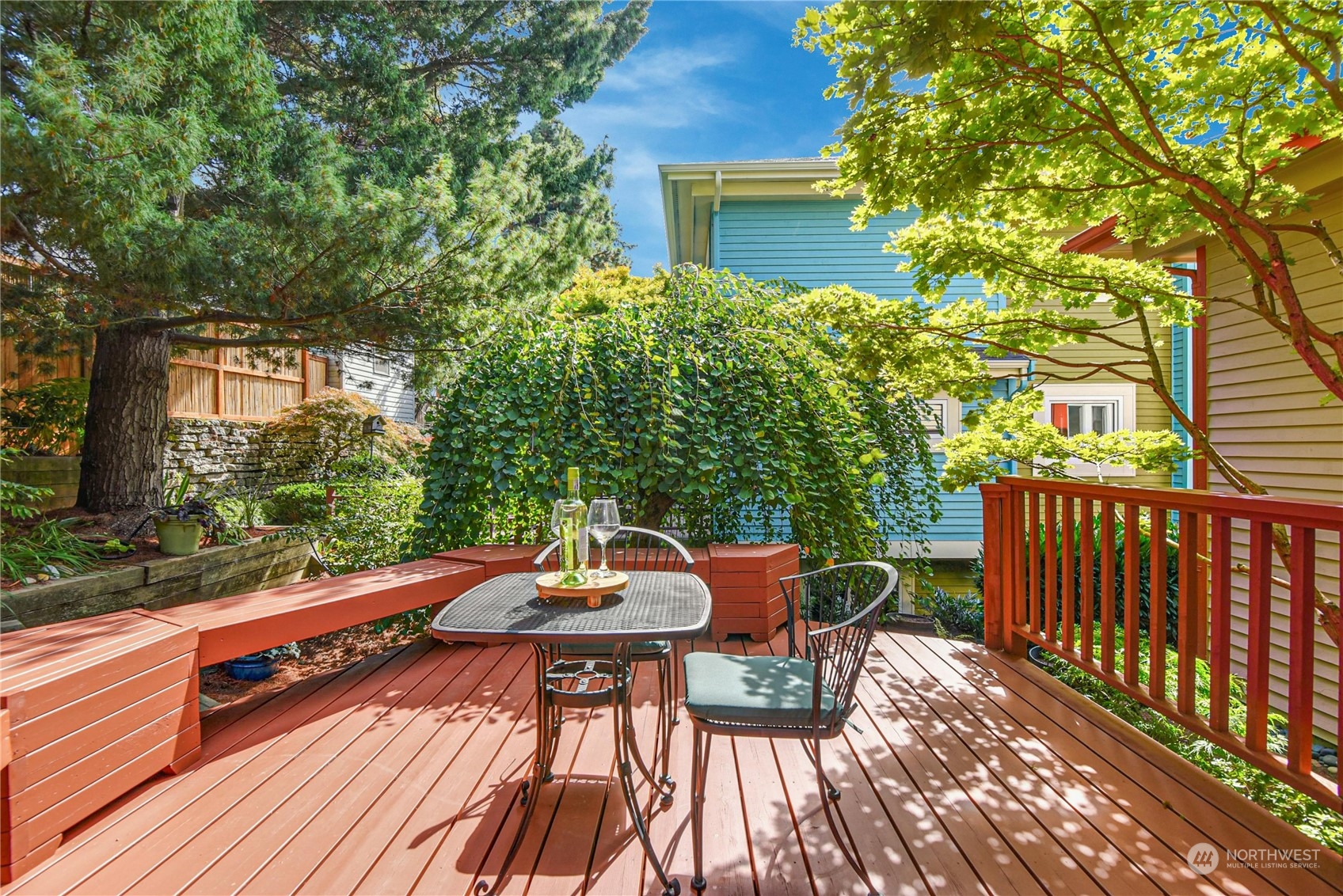 1310 North 41st Street, Unit B Seattle, WA 98103 - Photo 16 of 40 a view of a patio with a table and chairs next to a yard