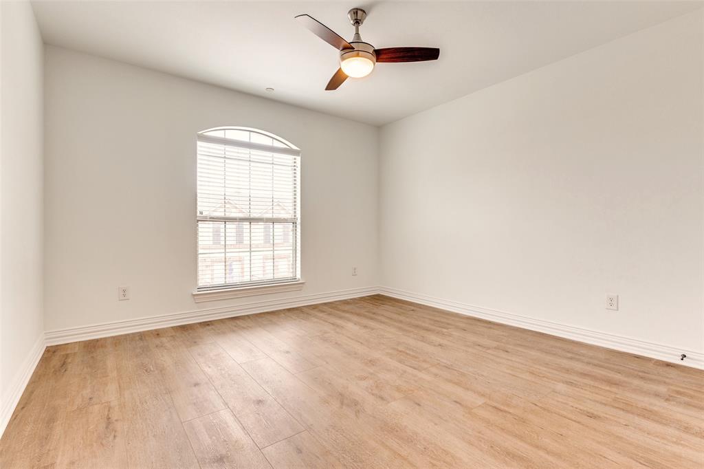 5713 Butterfly Way Fairview, TX 75069 - Photo 18 of 32 a view of empty room with wooden floor and fan