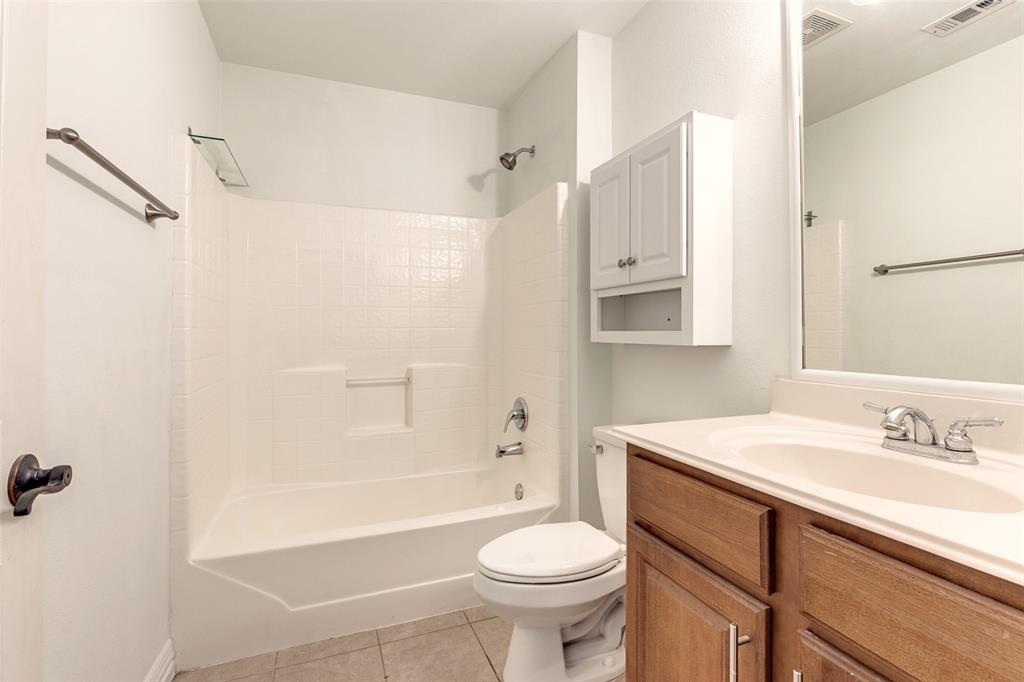 5713 Butterfly Way Fairview, TX 75069 - Photo 19 of 32 a bathroom with a sink toilet vanity and shower