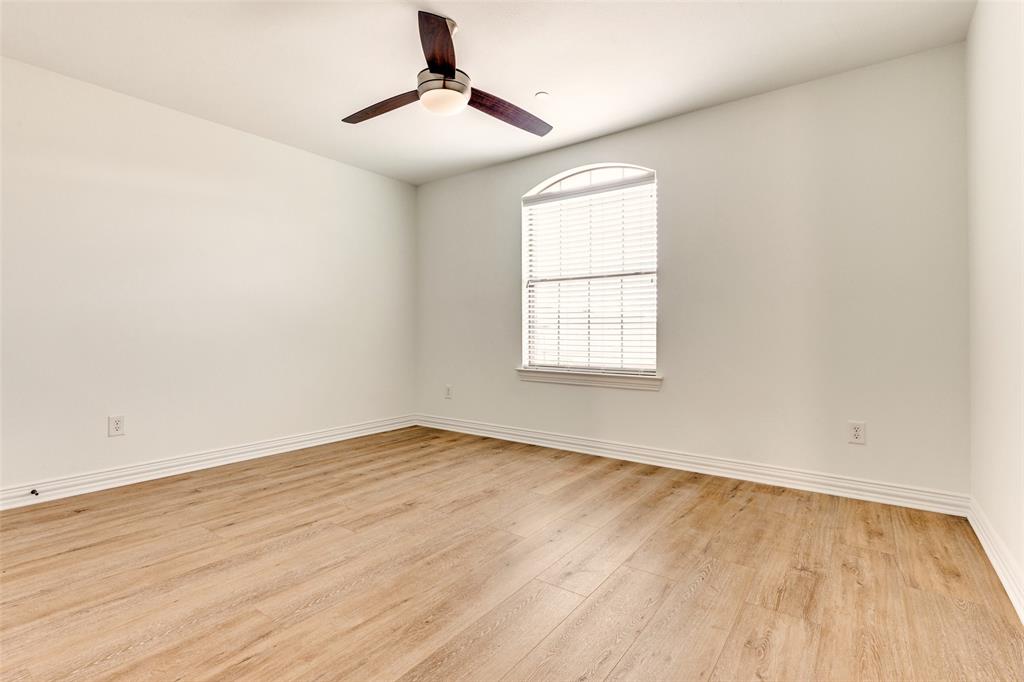 5713 Butterfly Way Fairview, TX 75069 - Photo 20 of 32 an empty room with wooden floor chandelier fan and windows