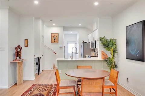 a view of a dining room with furniture and a potted plant