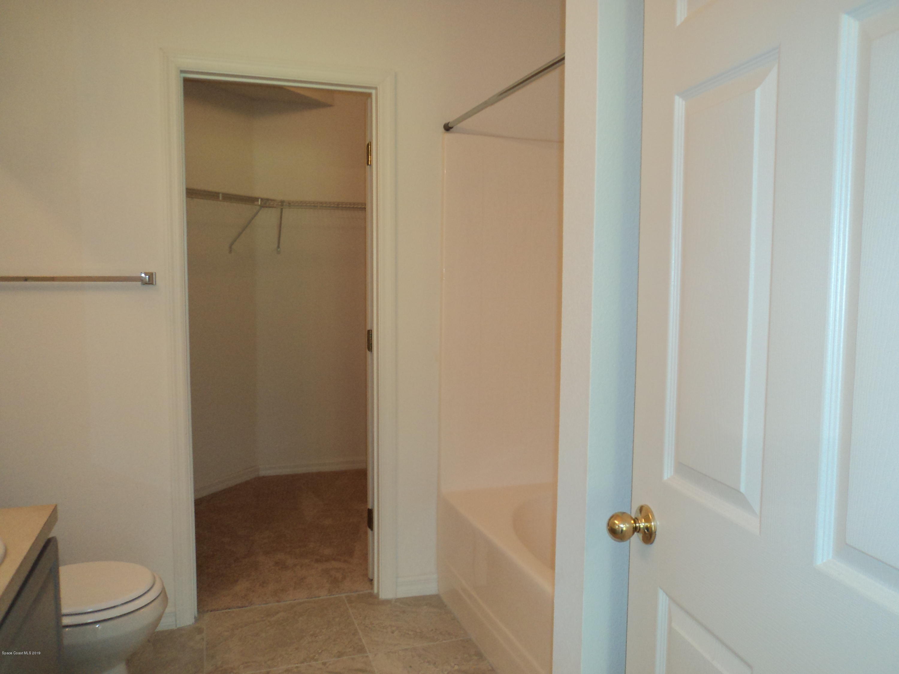 1685 Wacker Avenue Southeast Palm Bay, FL 32909 - Photo 14 of 30 a bathroom with a granite countertop toilet and a sink