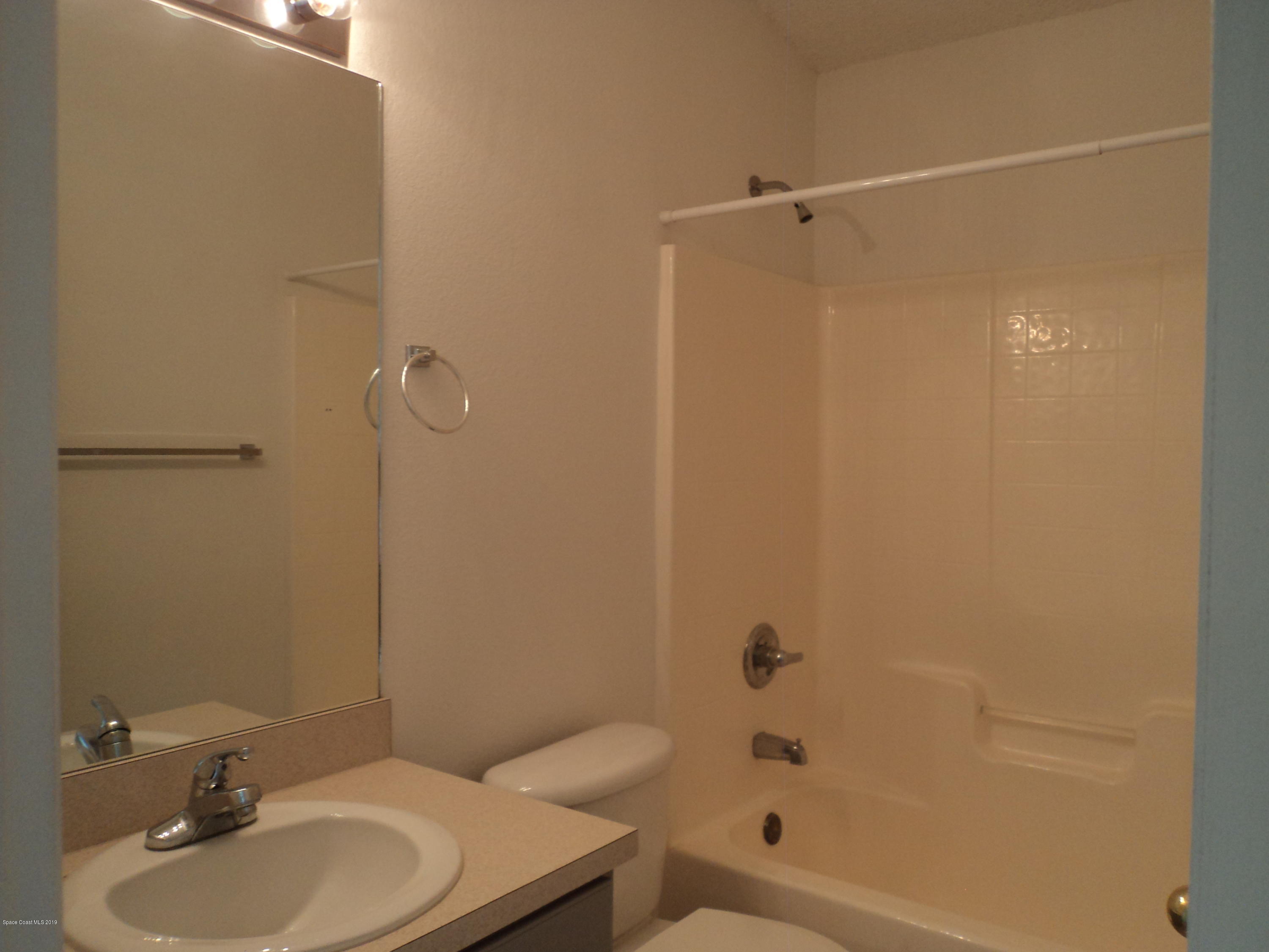 1685 Wacker Avenue Southeast Palm Bay, FL 32909 - Photo 21 of 30 a bathroom with a sink toilet and shower