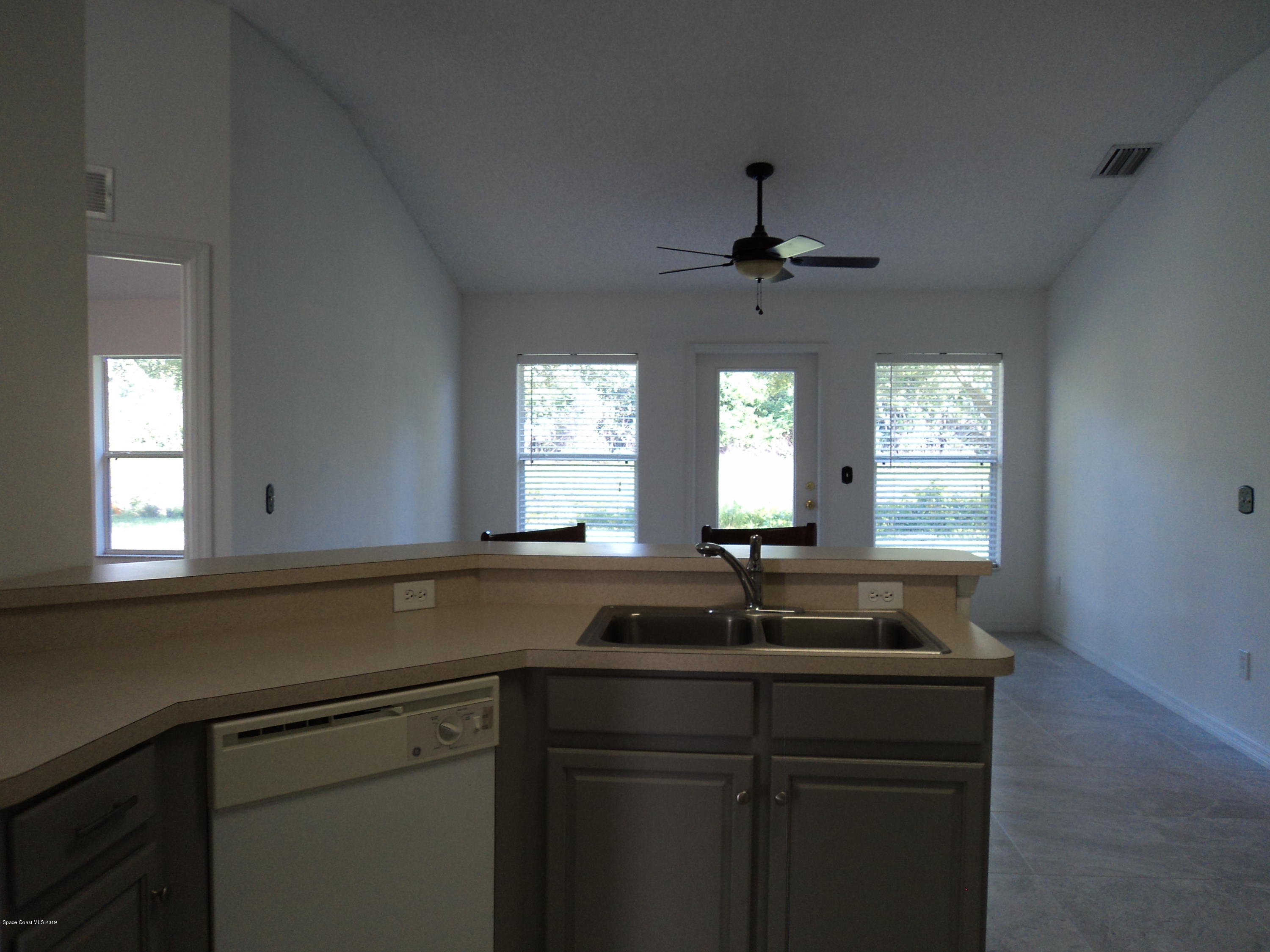 1685 Wacker Avenue Southeast Palm Bay, FL 32909 - Photo 22 of 30 a kitchen with a sink and a window