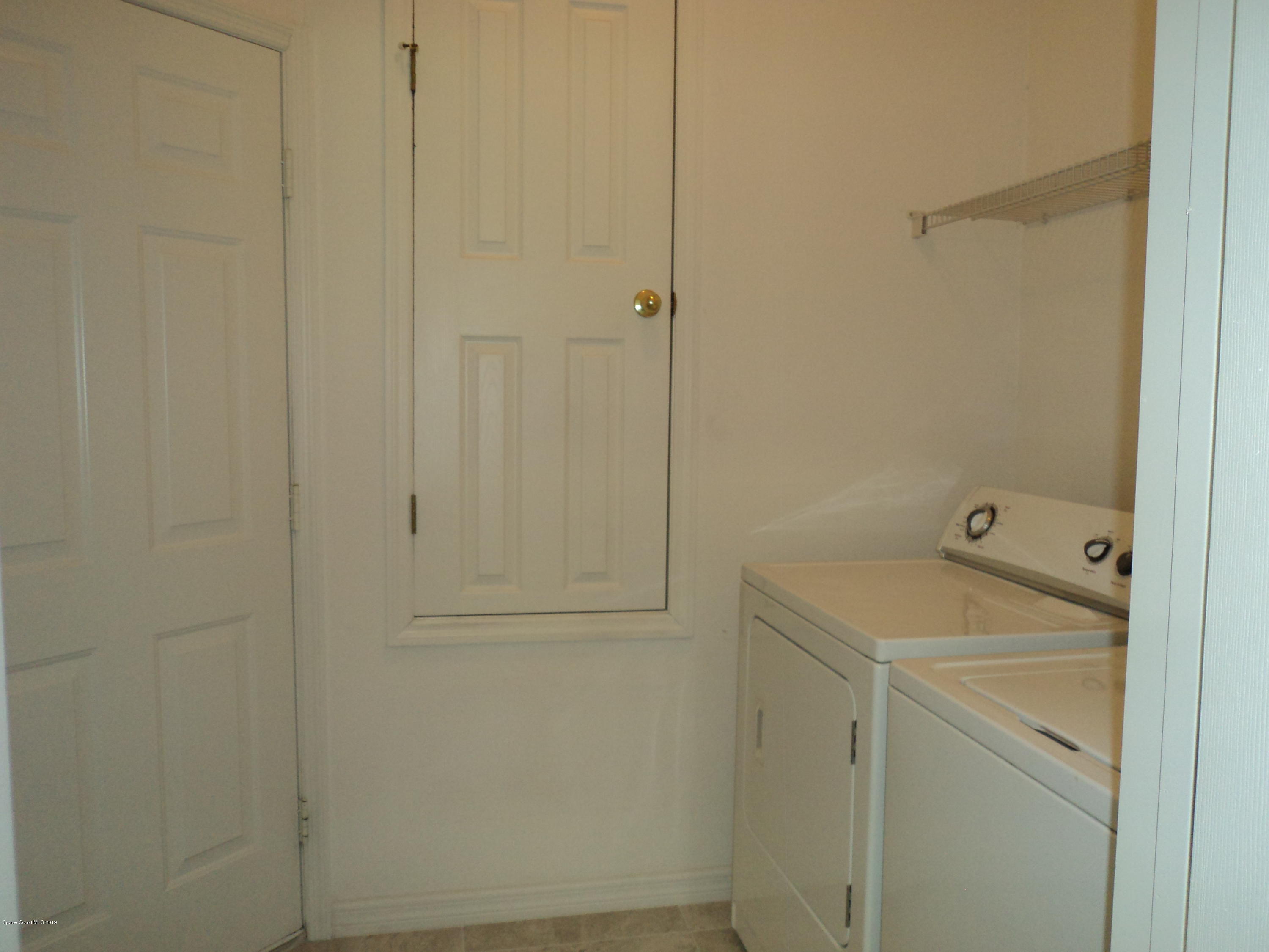 1685 Wacker Avenue Southeast Palm Bay, FL 32909 - Photo 23 of 30 a utility room with dryer and washer