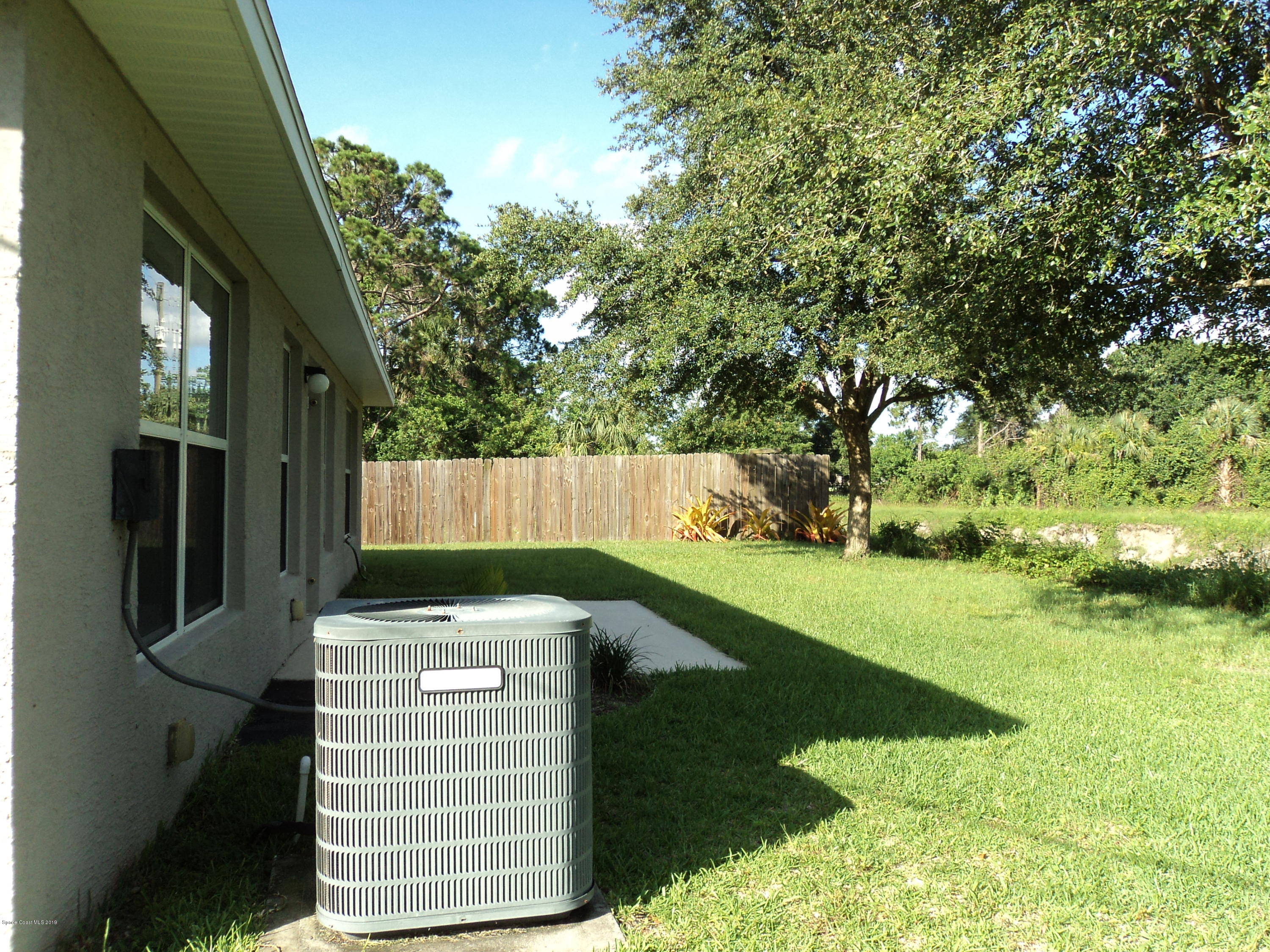 1685 Wacker Avenue Southeast Palm Bay, FL 32909 - Photo 25 of 30 a backyard of a house with lots of green space