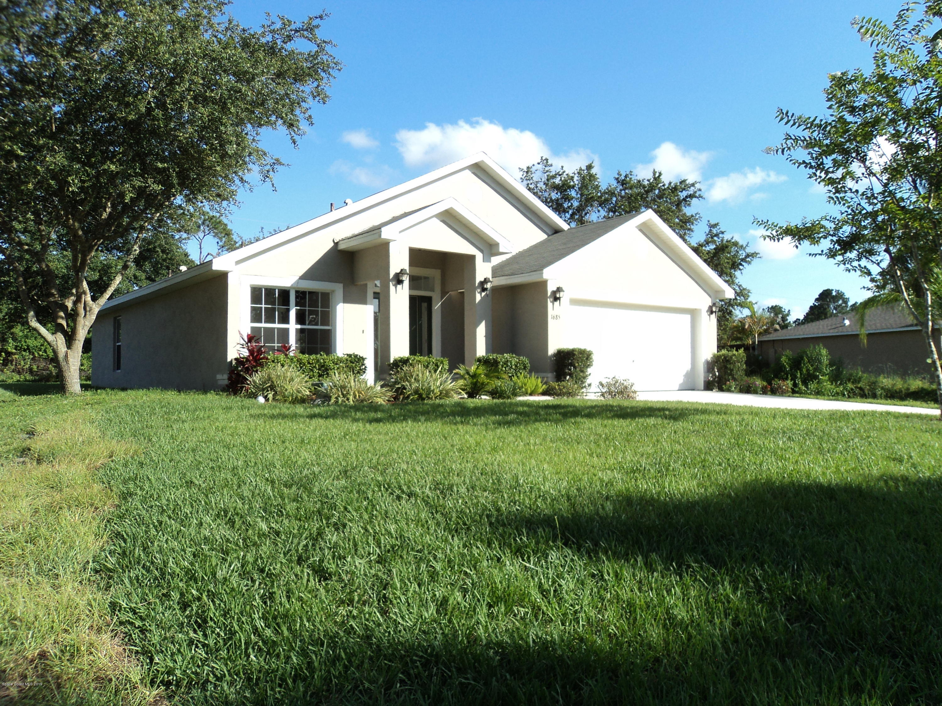 1685 Wacker Avenue Southeast Palm Bay, FL 32909 - Photo 28 of 30 a view of a house with yard and a garden