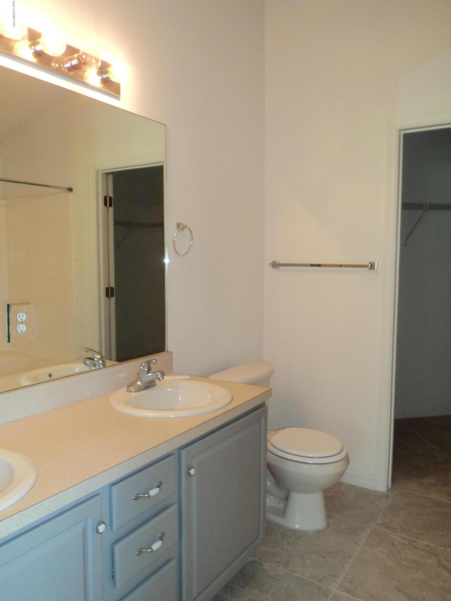 1685 Wacker Avenue Southeast Palm Bay, FL 32909 - Photo 4 of 30 a bathroom with a sink a toilet and shower