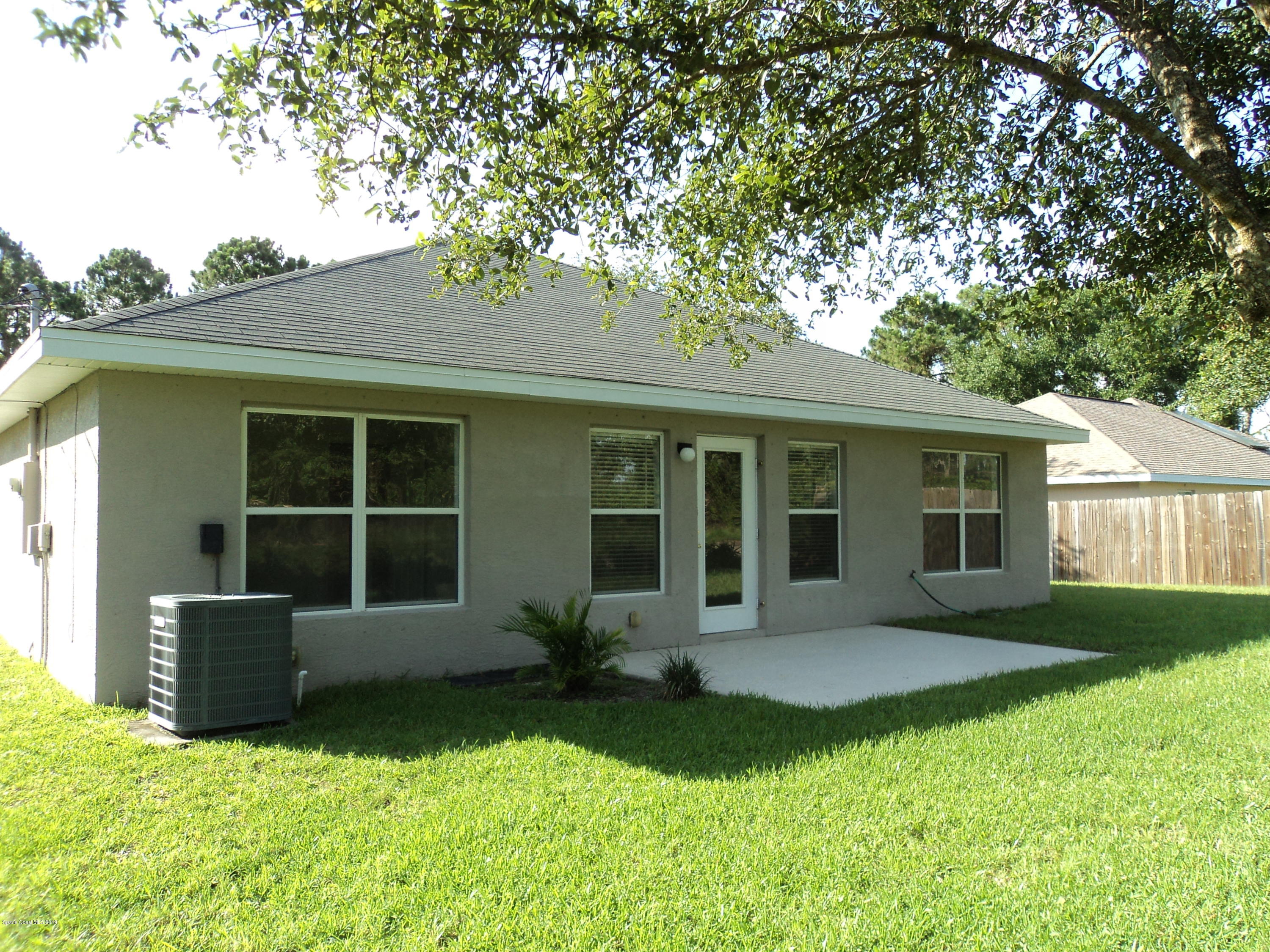 1685 Wacker Avenue Southeast Palm Bay, FL 32909 - Photo 6 of 30 front view of a house with a yard