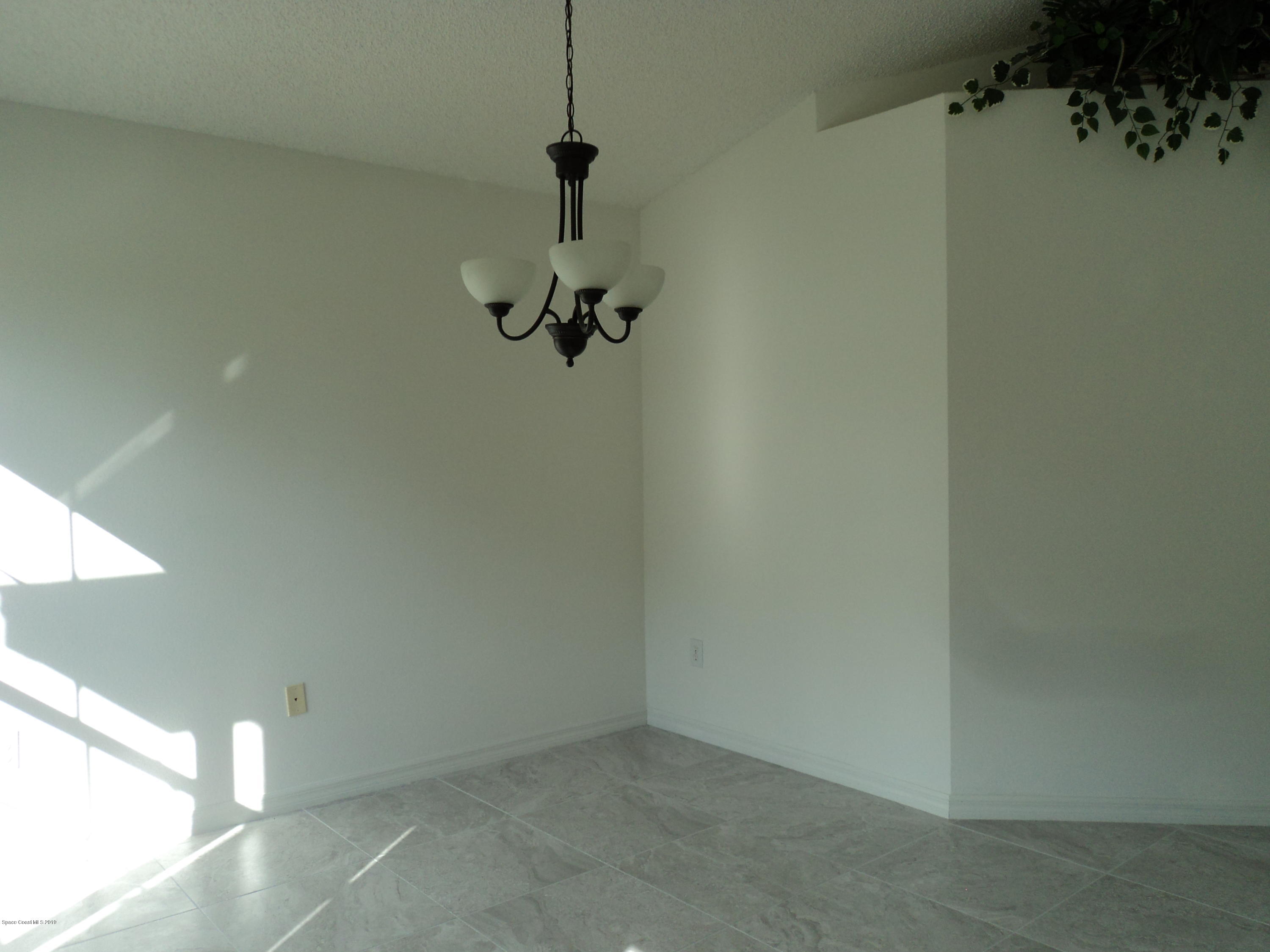 1685 Wacker Avenue Southeast Palm Bay, FL 32909 - Photo 8 of 30 a view of a room with a chandelier fan