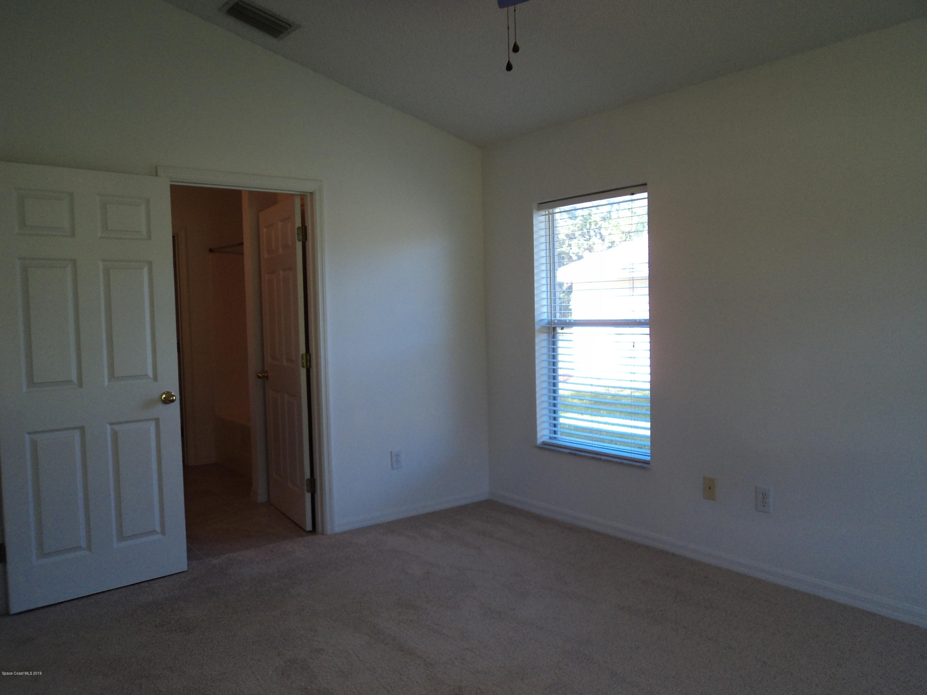 1685 Wacker Avenue Southeast Palm Bay, FL 32909 - Photo 10 of 30 an empty room with windows