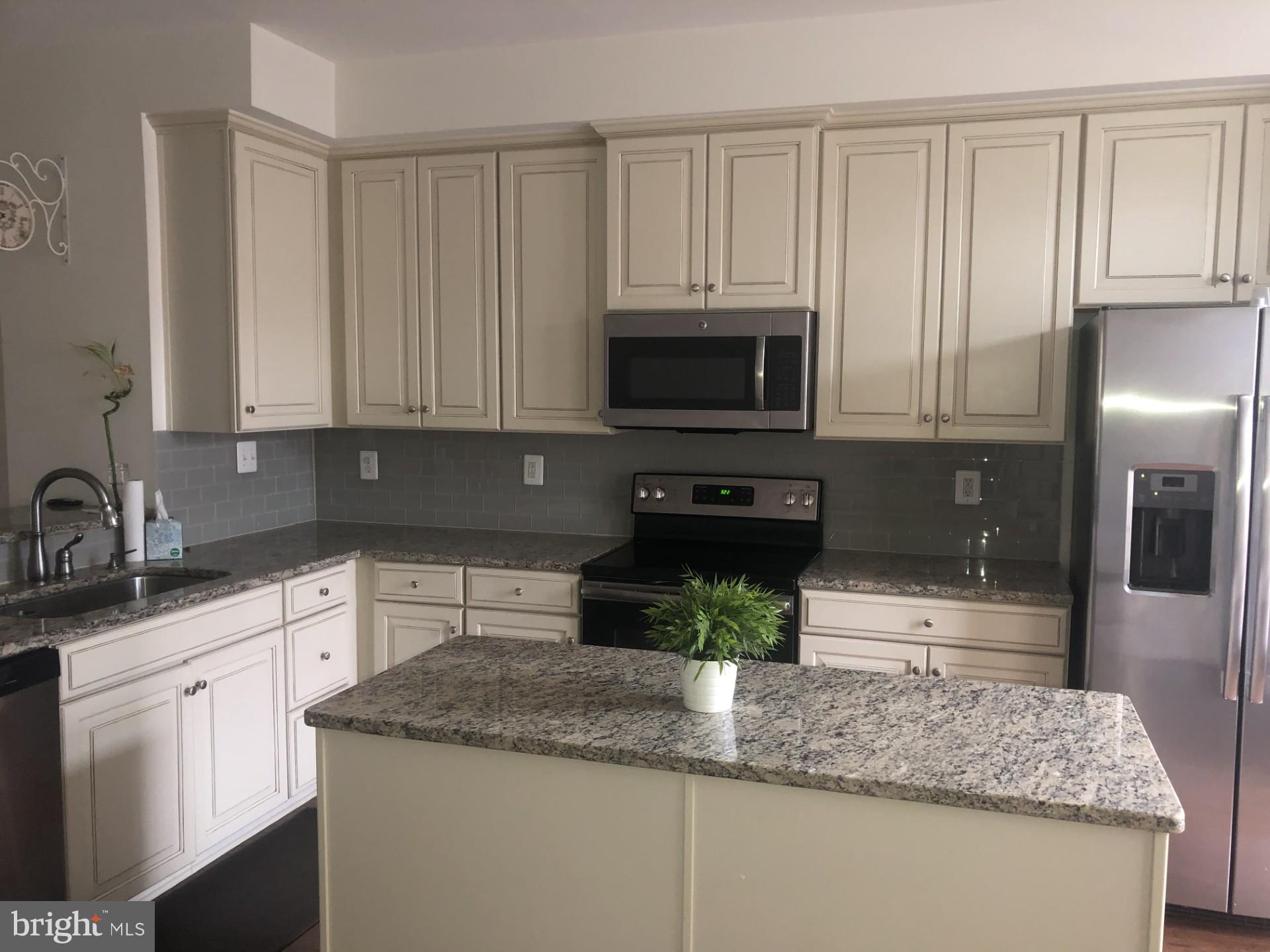 1728 Lantern Mews Baltimore, MD 21205 - Photo 4 of 16 a kitchen with appliances a sink and cabinets