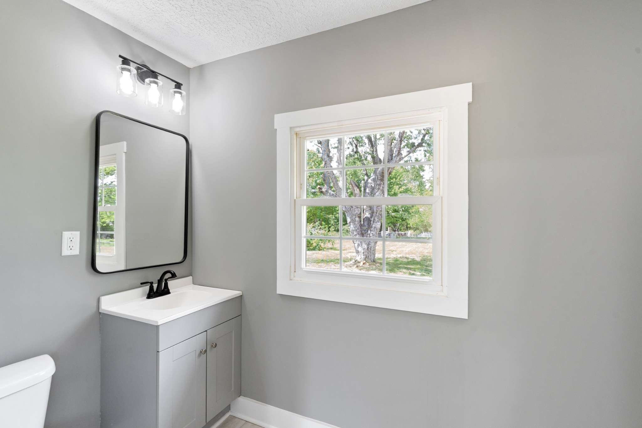 1503 5th Avenue West Springfield, TN 37172 - Photo 14 of 43 a bathroom with a sink a mirror and a window