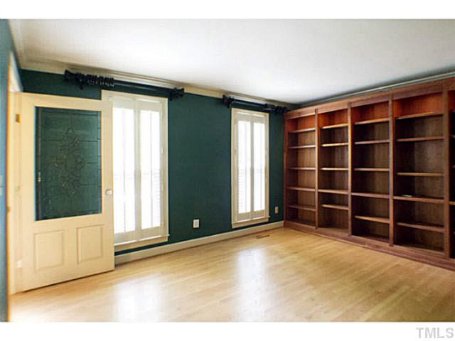 107 Kings Fork Road Cary, NC 27511 - Photo 12 of 25 Living room features: hardwood floors, built in bookcases and plantation shutters. This room can also be used as a wonderful study.