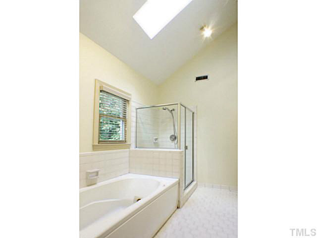107 Kings Fork Road Cary, NC 27511 - Photo 15 of 25 Master bath, separate tub and shower, vaulted ceiling, sky light and linen closet.