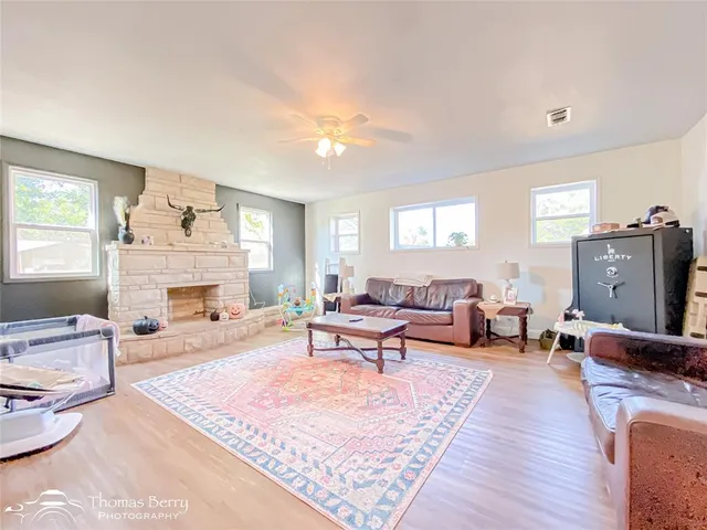 a living room with furniture and a fireplace