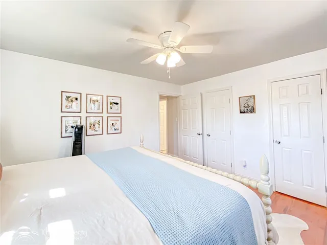 a bedroom with a large bed and a chandelier