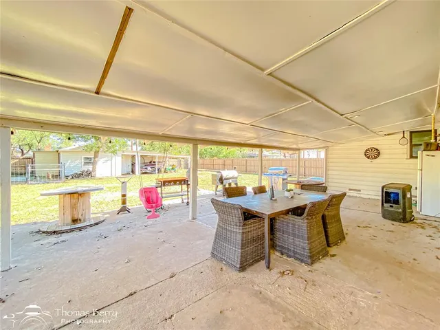 a view of a swimming pool with a table and chairs