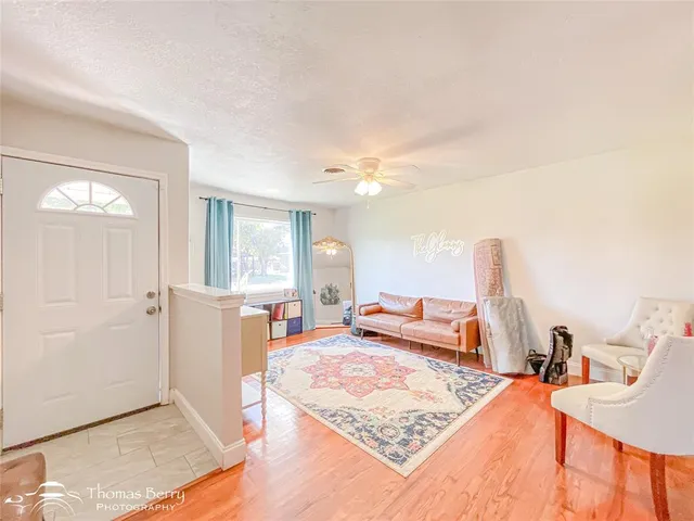 a bedroom with furniture and a wooden floor