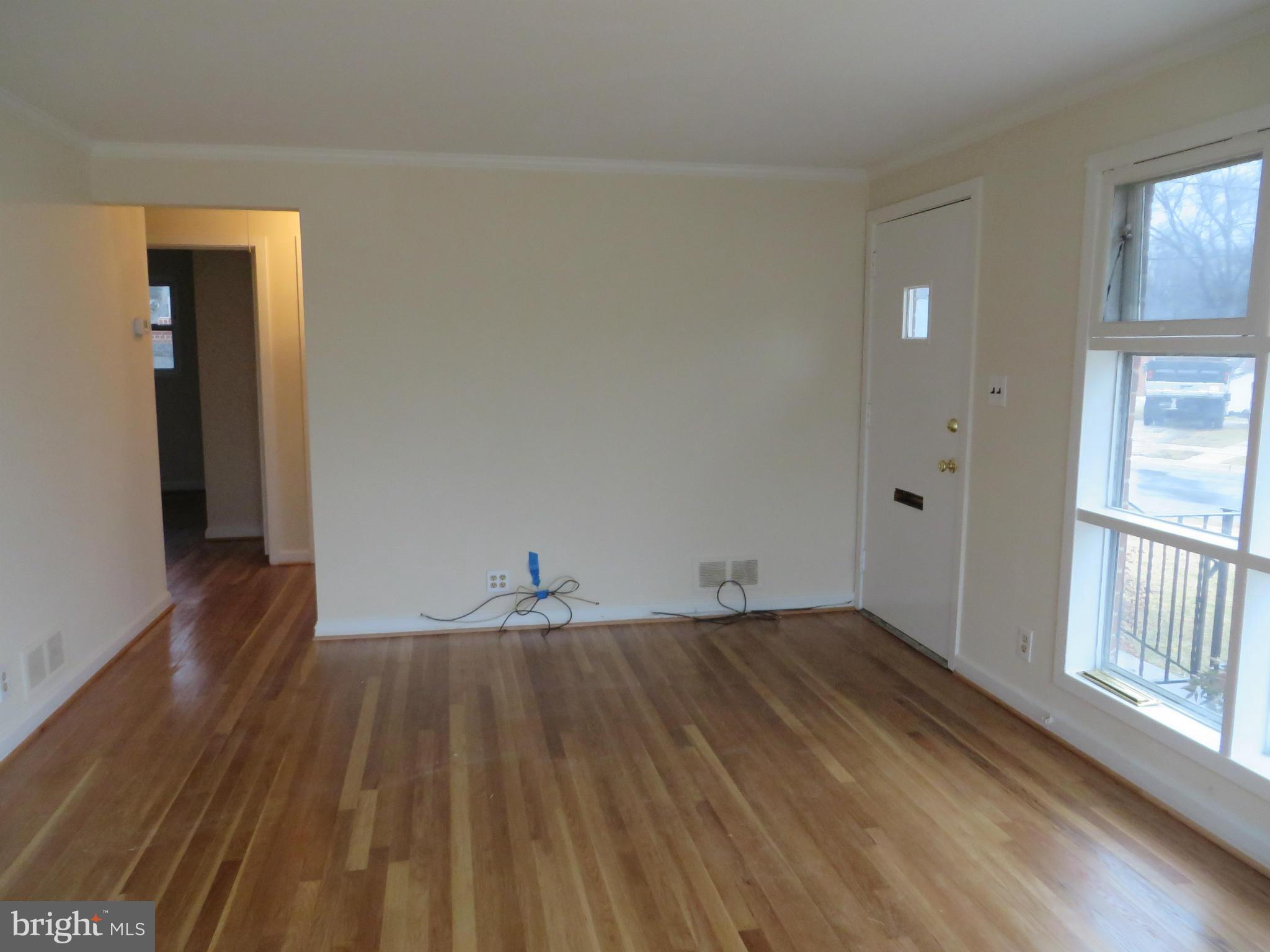 12200 Edgemont Street Silver Spring, MD 20902 - Photo 3 of 12 an empty room with wooden floor and windows