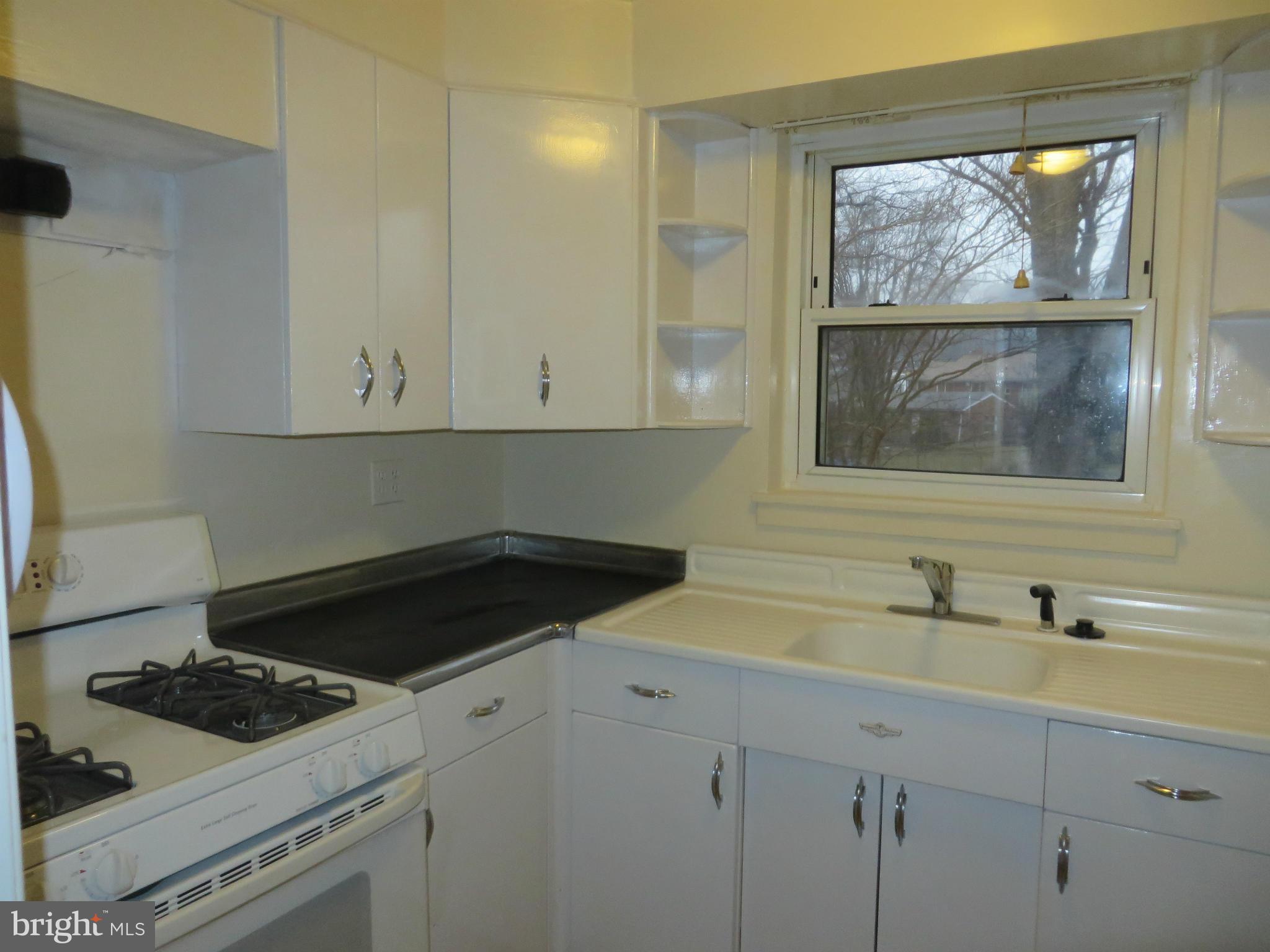 12200 Edgemont Street Silver Spring, MD 20902 - Photo 5 of 12 a kitchen with a stove and a sink