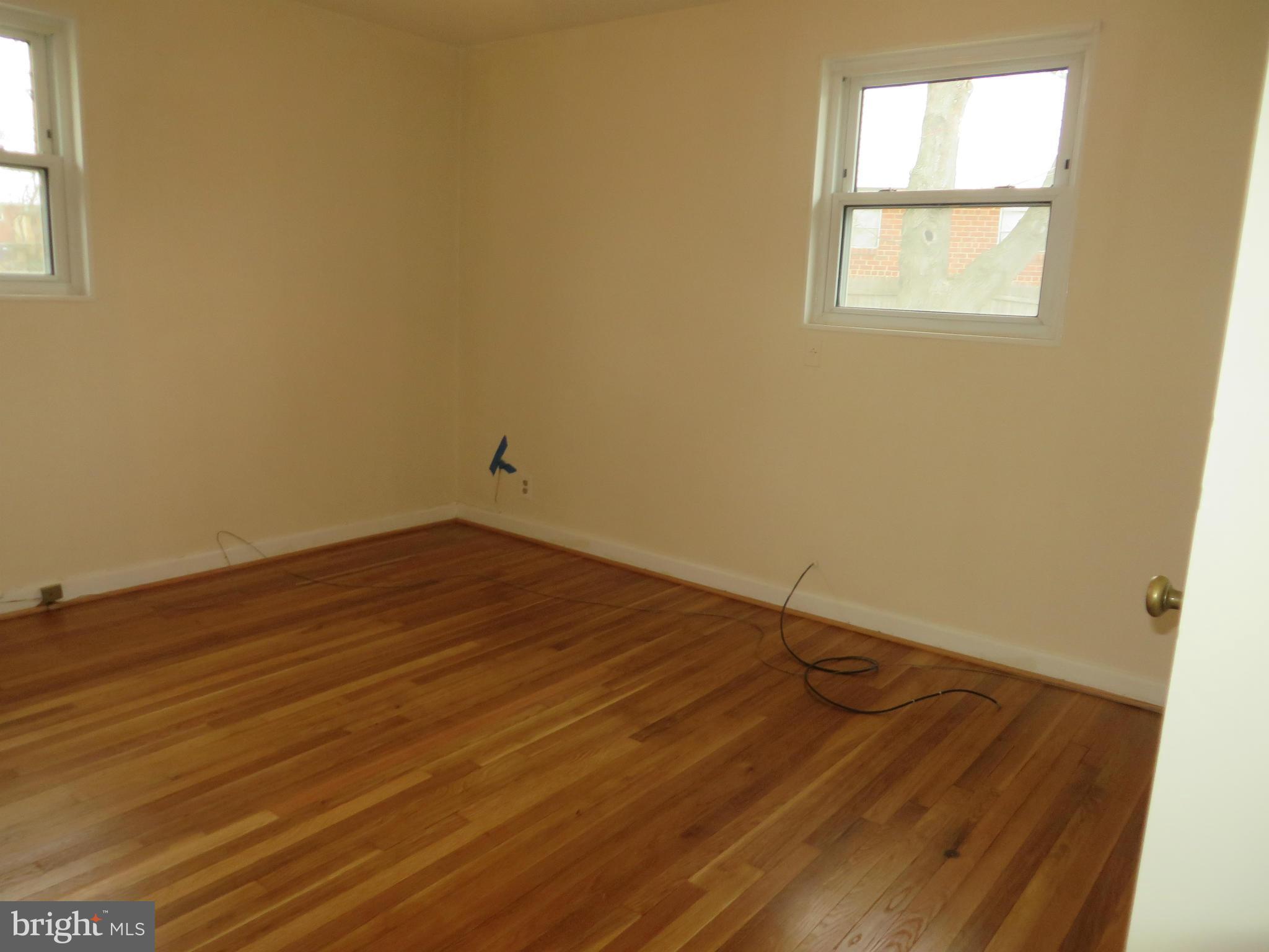 12200 Edgemont Street Silver Spring, MD 20902 - Photo 6 of 12 an empty room with wooden floor and windows