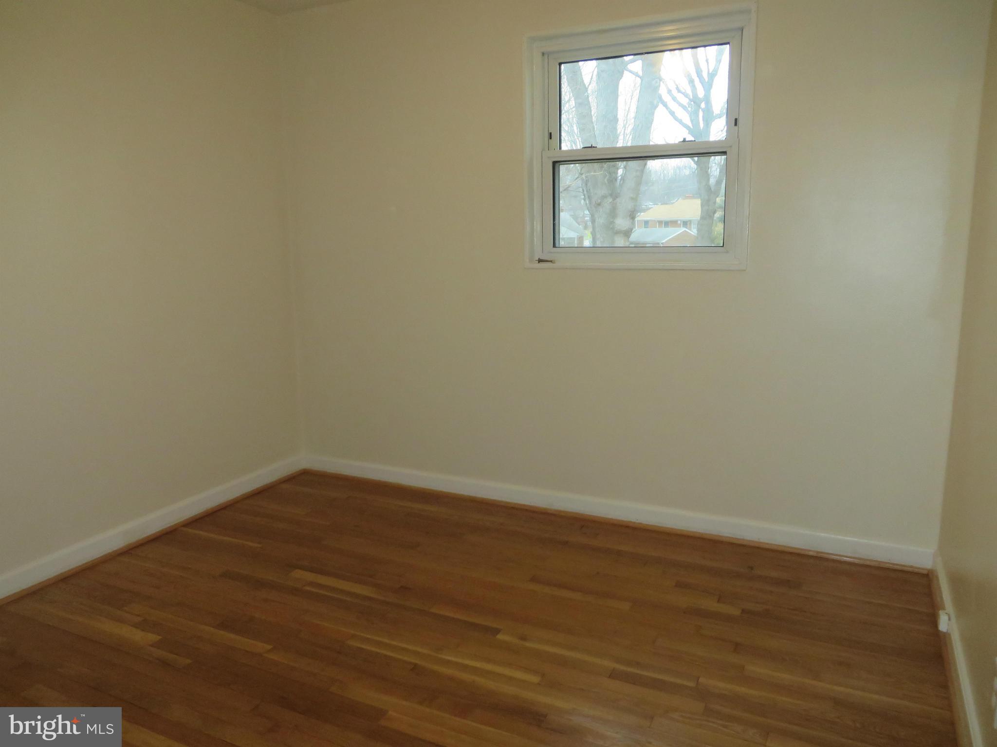 12200 Edgemont Street Silver Spring, MD 20902 - Photo 7 of 12 an empty room with wooden floor and windows