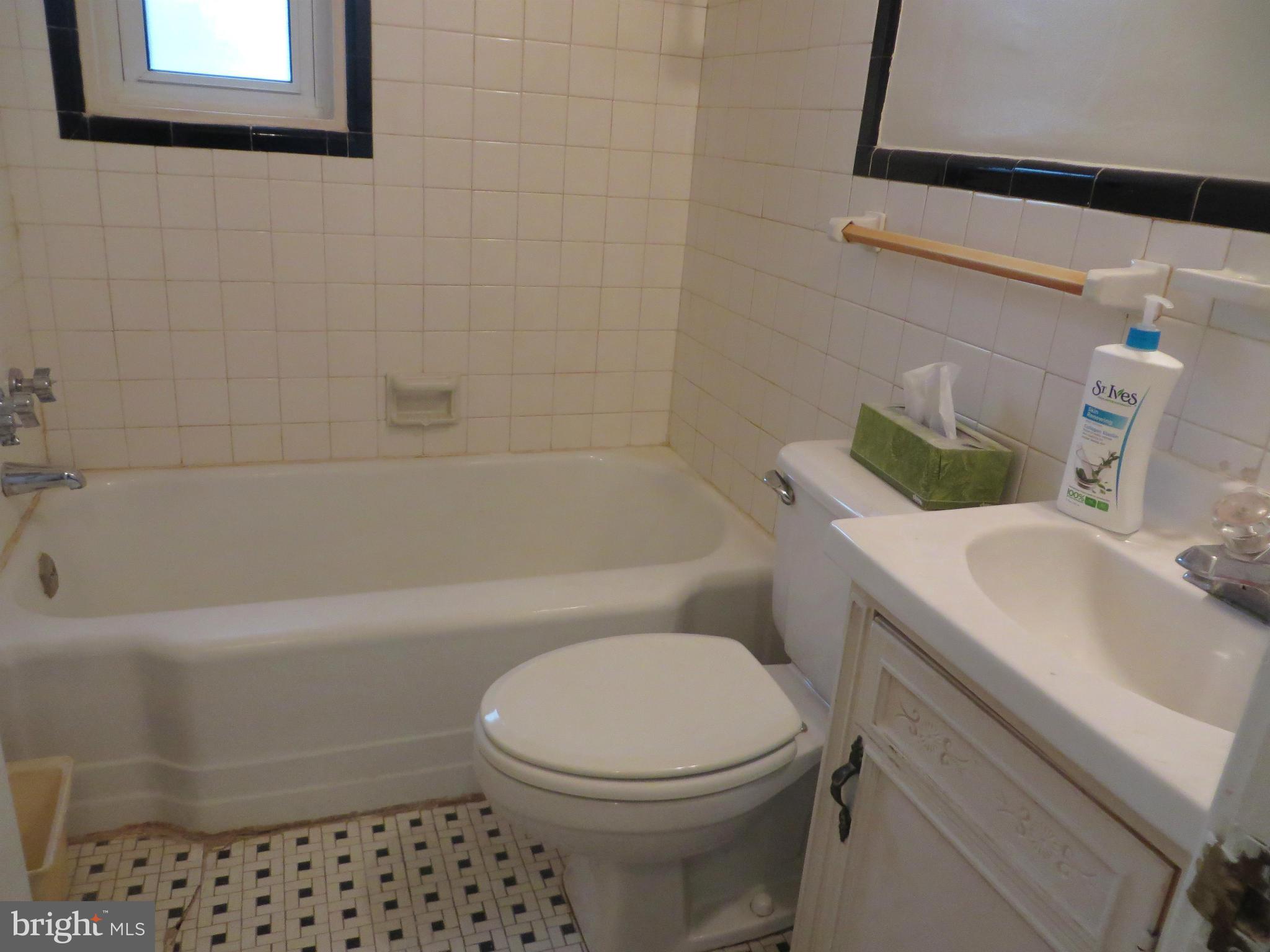 12200 Edgemont Street Silver Spring, MD 20902 - Photo 9 of 12 a white toilet sitting next to a bath tub