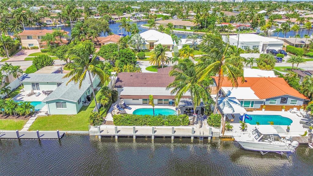 an aerial view of house with yard swimming pool and outdoor seating
