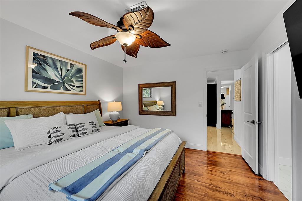 1080 Southeast 9th Avenue Pompano Beach, FL 33060 - Photo 16 of 53 a spacious bedroom with a bed and a chandelier