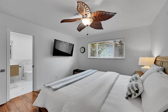 a bedroom with a bed and a flat screen tv