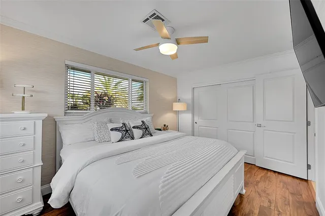 a bedroom with a bed window and a chandelier