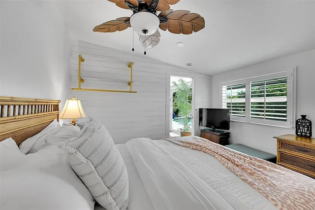 a bedroom with a bed window and a chandelier