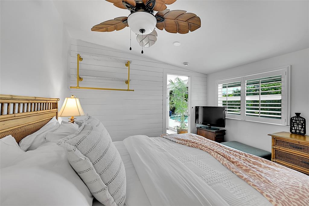 1080 Southeast 9th Avenue Pompano Beach, FL 33060 - Photo 28 of 53 a bedroom with a bed window and a chandelier