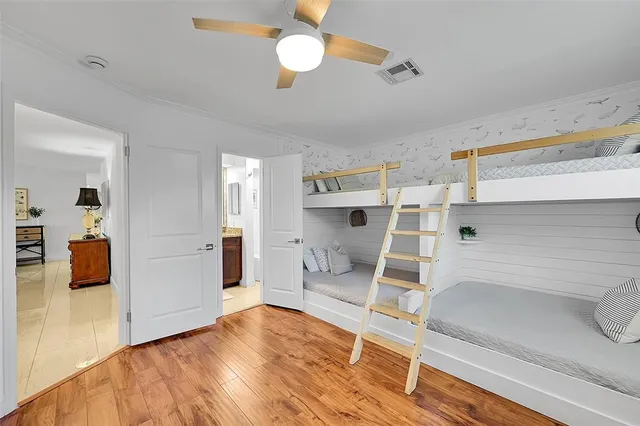 a kitchen with stainless steel appliances wooden floor and chandelier
