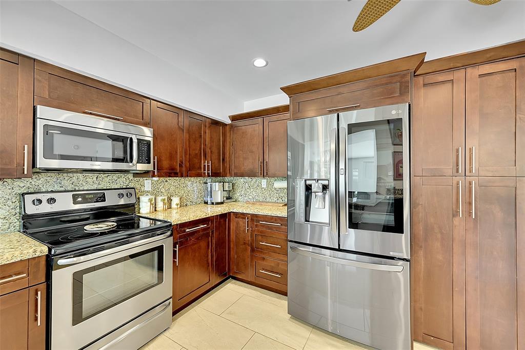 1080 Southeast 9th Avenue Pompano Beach, FL 33060 - Photo 3 of 53 a kitchen with a refrigerator stove and microwave