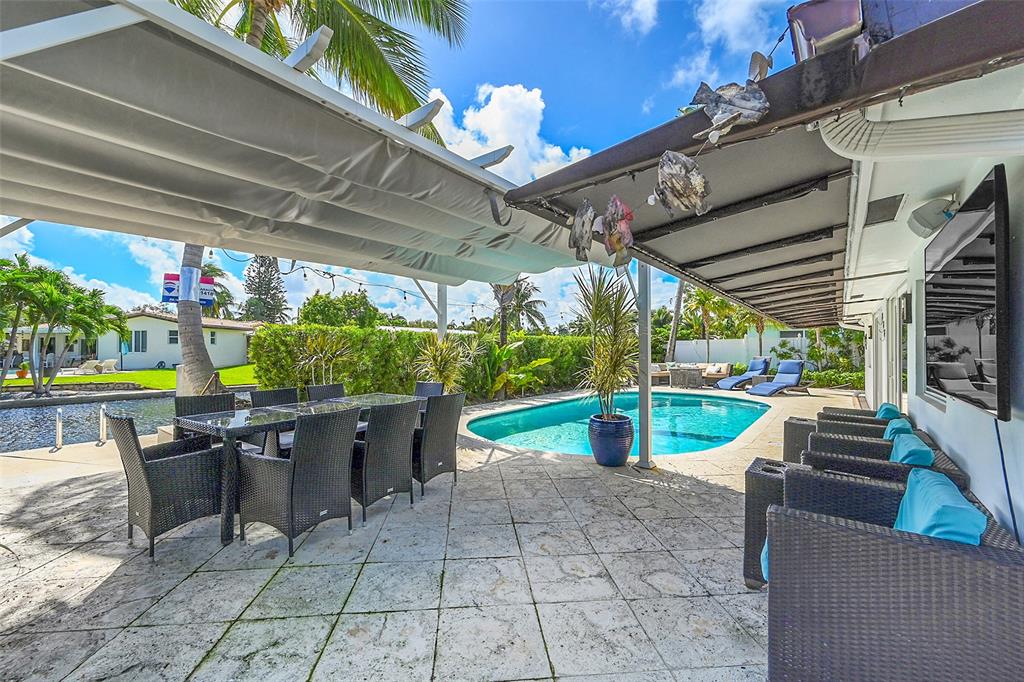 1080 Southeast 9th Avenue Pompano Beach, FL 33060 - Photo 32 of 53 a view of a chairs and table in patio with a barbeque grill