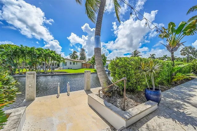 a building outdoor space with patio furniture and potted plants
