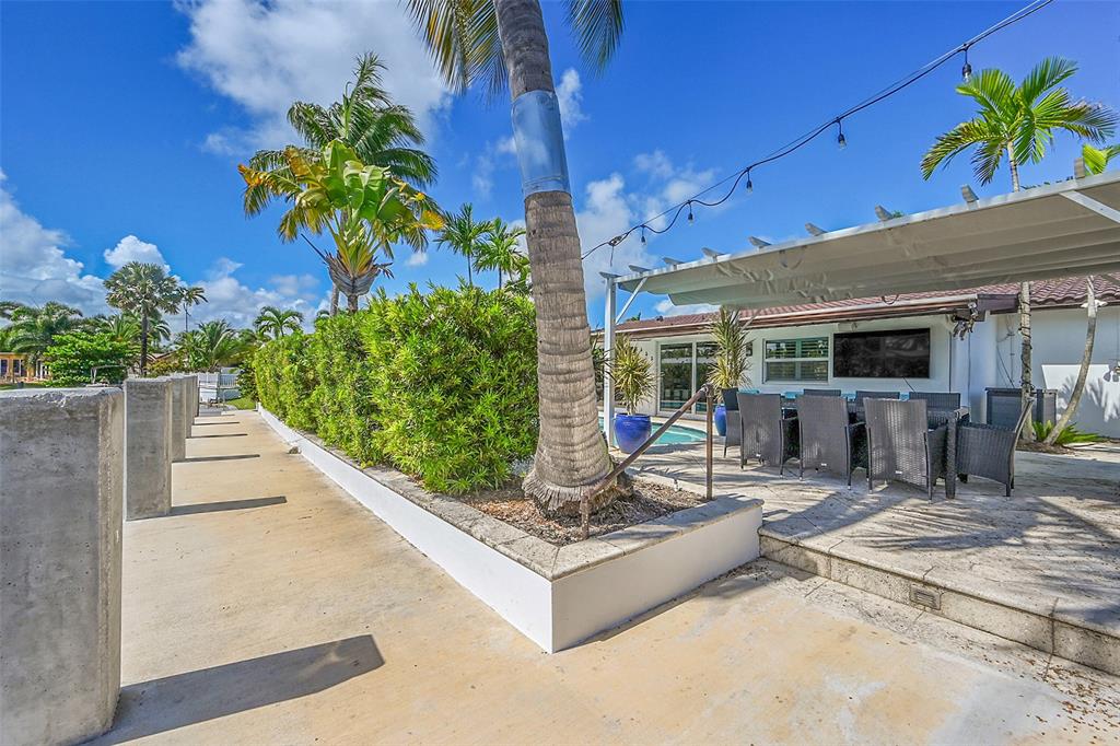 1080 Southeast 9th Avenue Pompano Beach, FL 33060 - Photo 35 of 53 a building outdoor space with patio furniture and potted plants