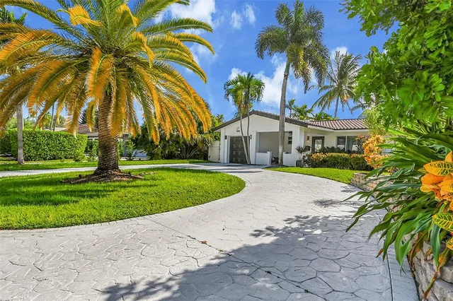 a front view of a house with a garden and yard