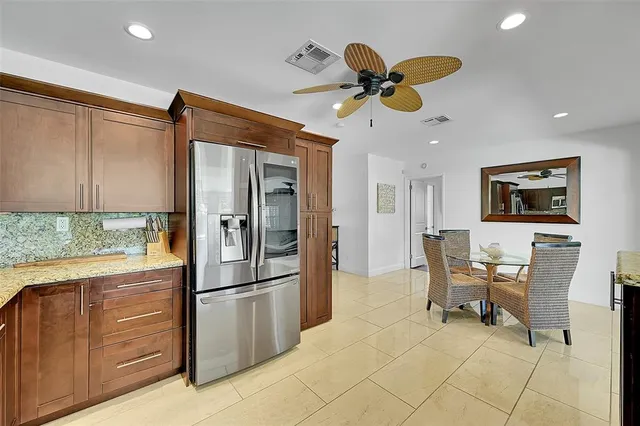 a kitchen with stainless steel appliances granite countertop a refrigerator and a sink