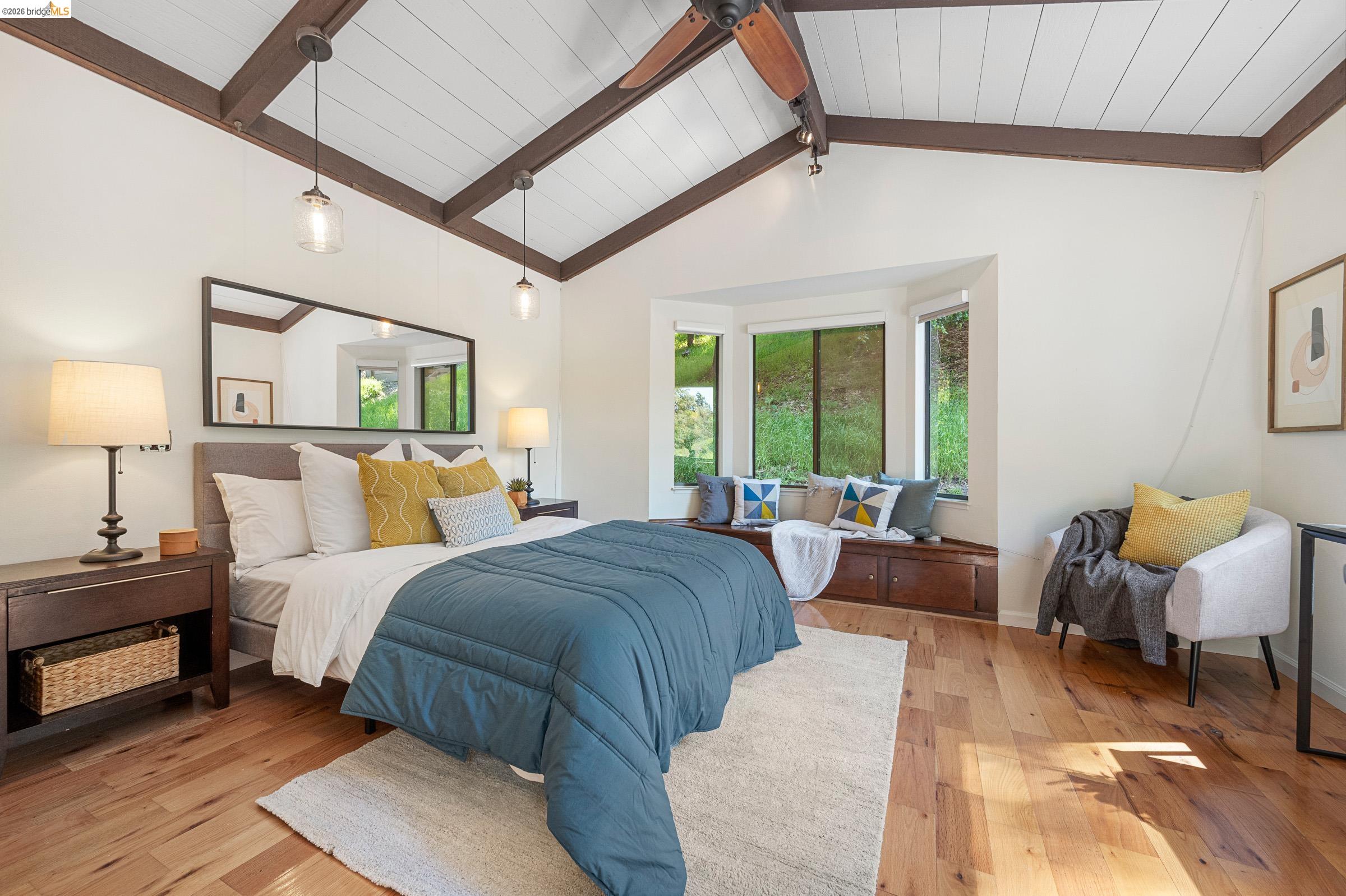 6600 Heather Ridge Way Oakland, CA 94611 - Photo 38 of 66 Vaulted ceiling with exposed wood beams and wood-finish flooring