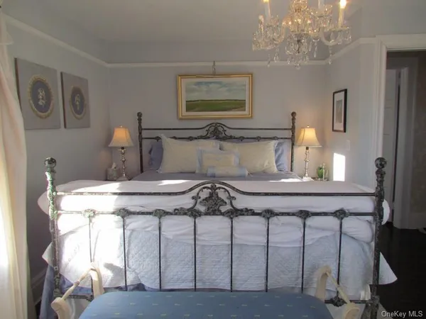 a view of a dining room with furniture and a chandelier