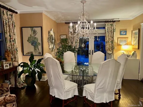 a view of a dining room with furniture and chandelier