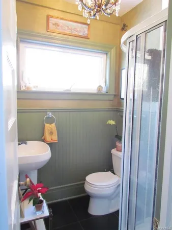 a white toilet sitting next to a bathroom sink