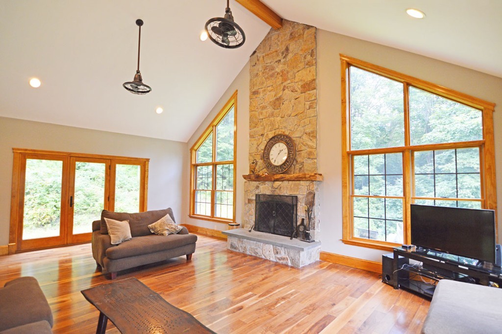 391 S Road Hampden, MA 01036 - Photo 3 of 28 a living room with furniture a fireplace and a flat screen tv