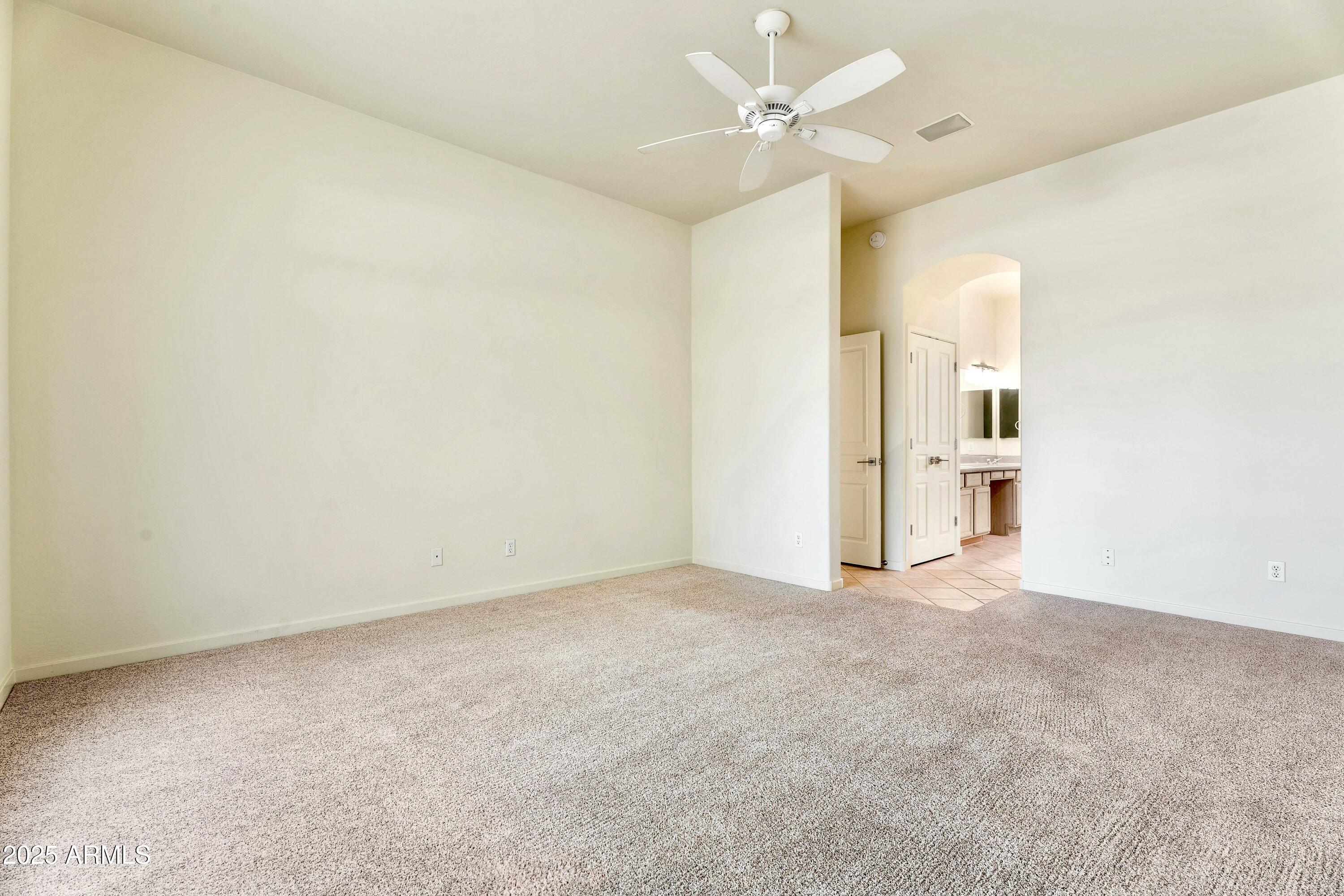 3830 East Carter Drive Phoenix, AZ 85042 - Photo 14 of 30 an empty room with a empty space and a ceiling fan