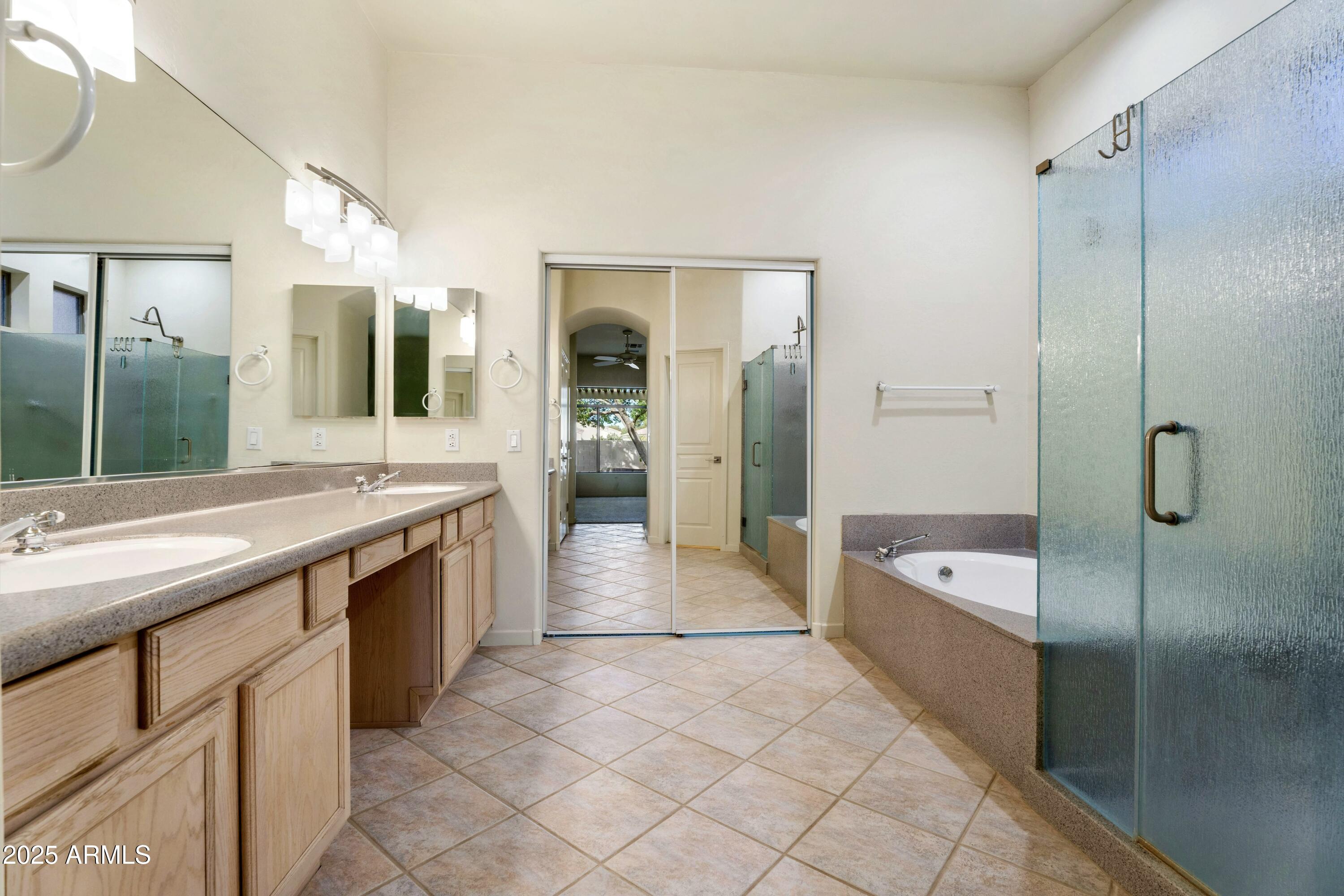 3830 East Carter Drive Phoenix, AZ 85042 - Photo 16 of 30 a spacious bathroom with a granite countertop sink a large mirror and a bathtub