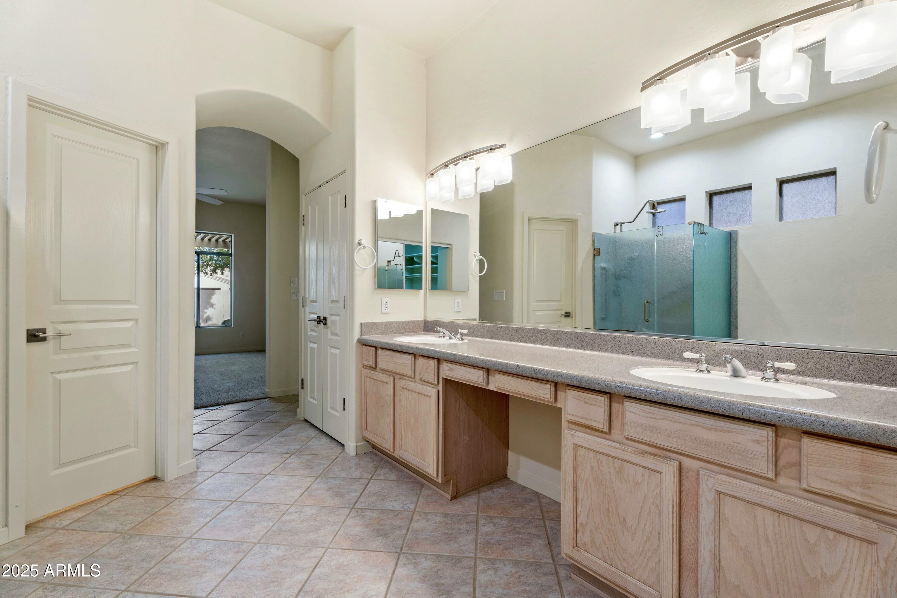 3830 East Carter Drive Phoenix, AZ 85042 - Photo 17 of 30 a spacious bathroom with a granite countertop sink mirror and a